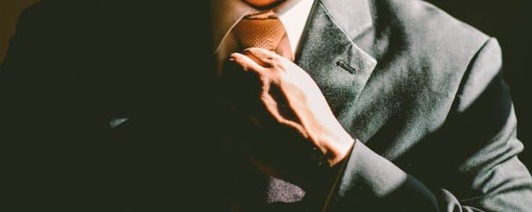 Man adjusting his tie