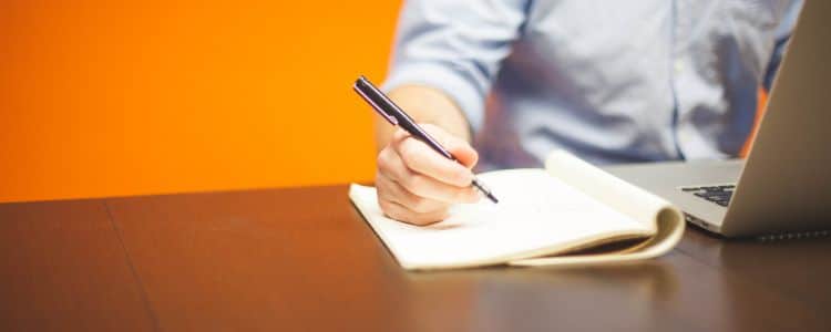 Man writing in notebook