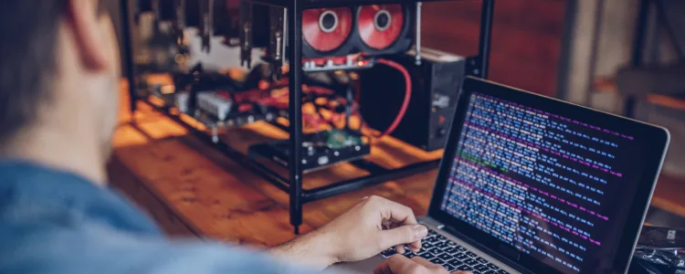 man using laptop for crypto mining
